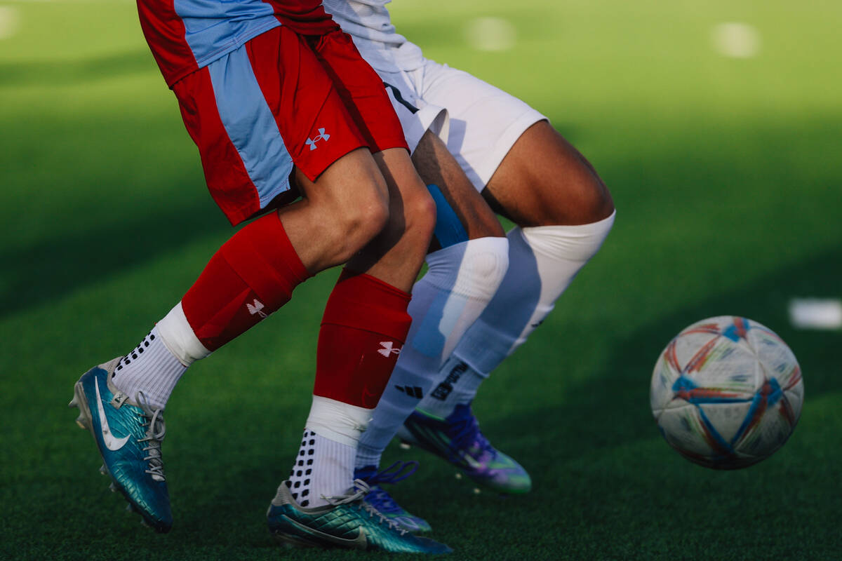 Soccer players chase the ball during a high school boys soccer game between Western and Las Veg ...
