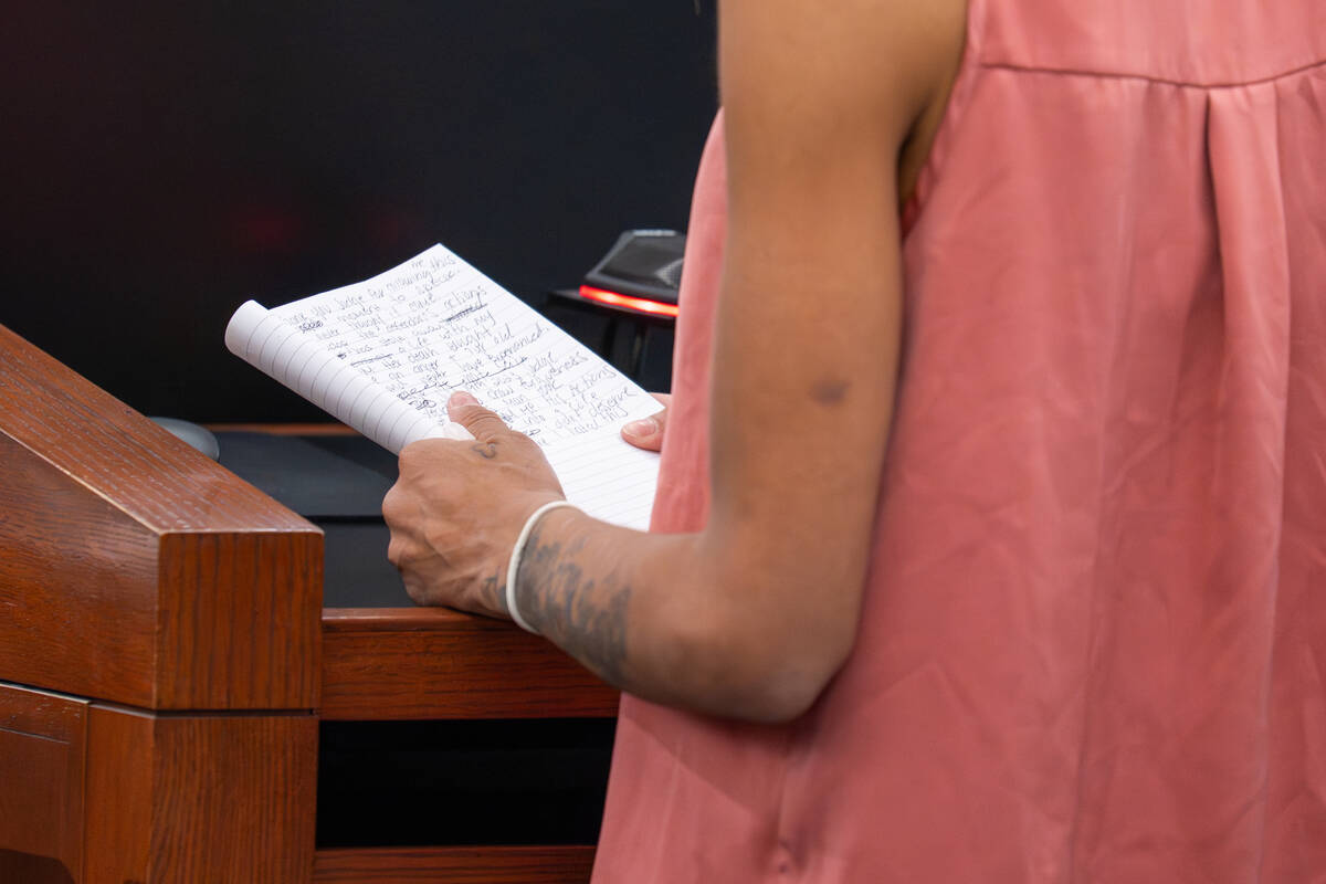 Courtney Foster reads from a notebook while delivering her impact statement in court about the ...