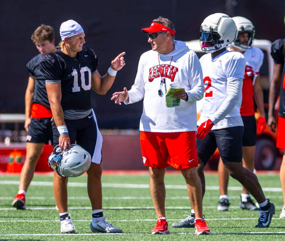 UNLV head coach Dan Mullen talks with quarterback Anthony Colandrea (10) during football practi ...