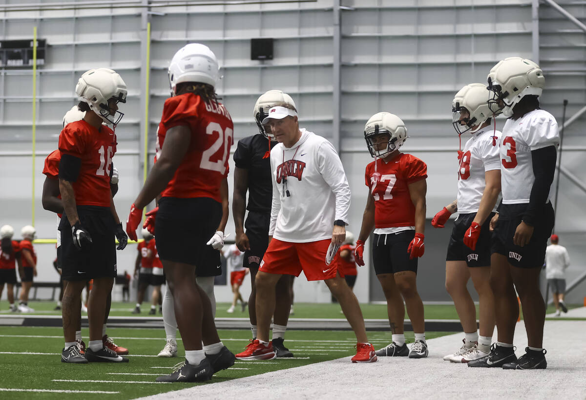 UNLV head coach Dan Mullen, center, coaches players during football practice at the Raiders hea ...