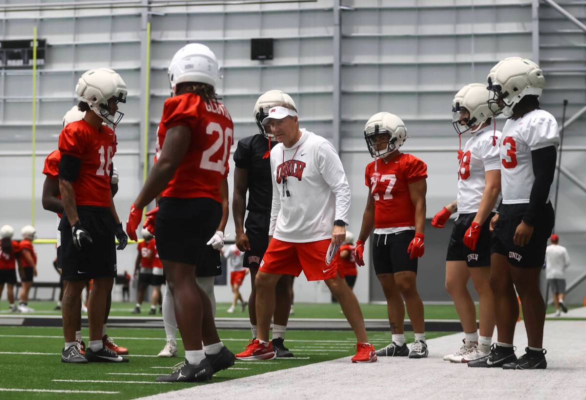 UNLV head coach Dan Mullen, center, coaches players during football practice at the Raiders hea ...