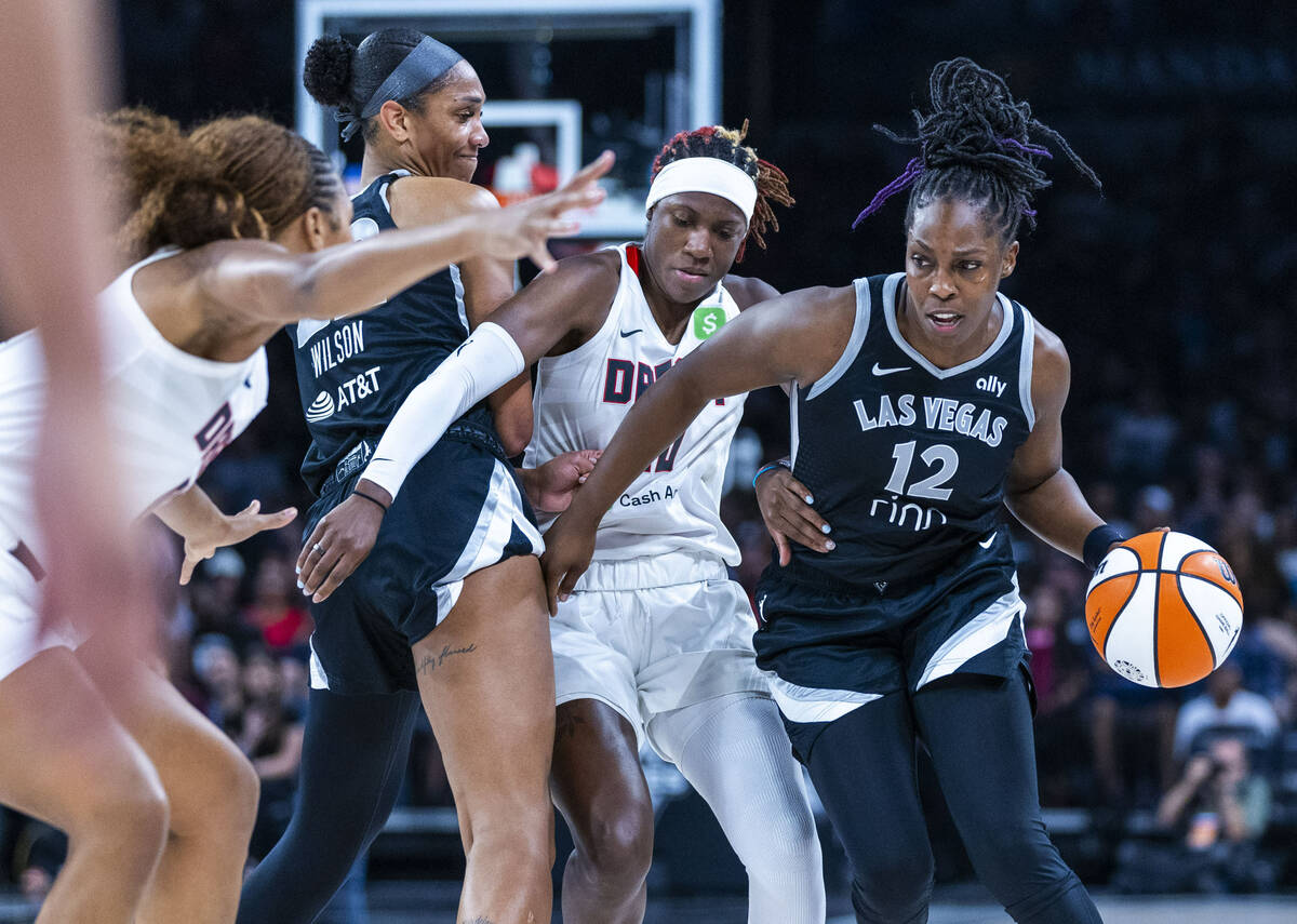 Aces guard Chelsea Gray (12) gets around Atlanta Dream guard Rhyne Howard (10) who gets picked ...