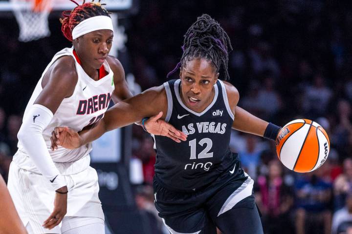 Aces guard Chelsea Gray (12) drives the lane as she battles with Atlanta Dream guard Rhyne Howa ...