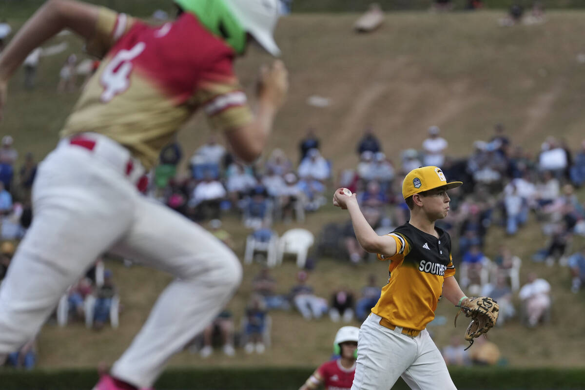 Irmo, S.C.'s Andrew Bogan, right, throws to first base during the first inning of a baseball ga ...