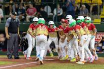 Las Vegas' Summerlin South Little League team greets Garrett Gallagos after Gallegos' three-run ...