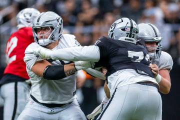 Raiders guard Jackson Powers-Johnson (58) blocks out Raiders defensive tackle Tank Booker (73) ...