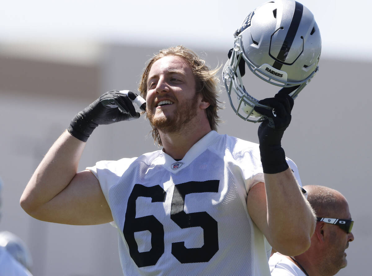 Raiders guard Alex Cappa (65) puts his helmet as he takes the field during the last day of an N ...