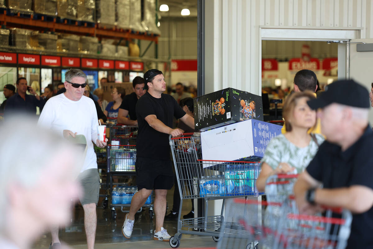 Shoppers exit the newly opened Costco at 6880 S. Buffalo Drive on Thursday, Aug. 21, 2025, in L ...