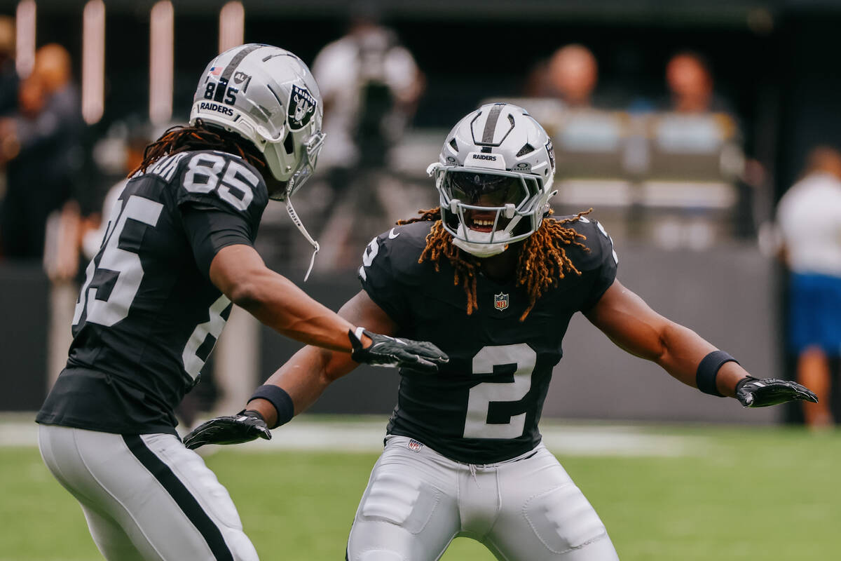 Raiders wide receiver Ketron Jackson Jr. (85) and Raiders running back Ashton Jeanty (2) hype e ...