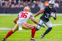 Raiders running back Raheem Mostert (31) looks to move around San Francisco 49ers safety Marque ...