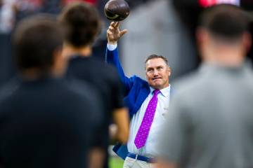 UNLV head coach Dan Mullen tosses a ball during warm ups before the first half of their NCAA fo ...