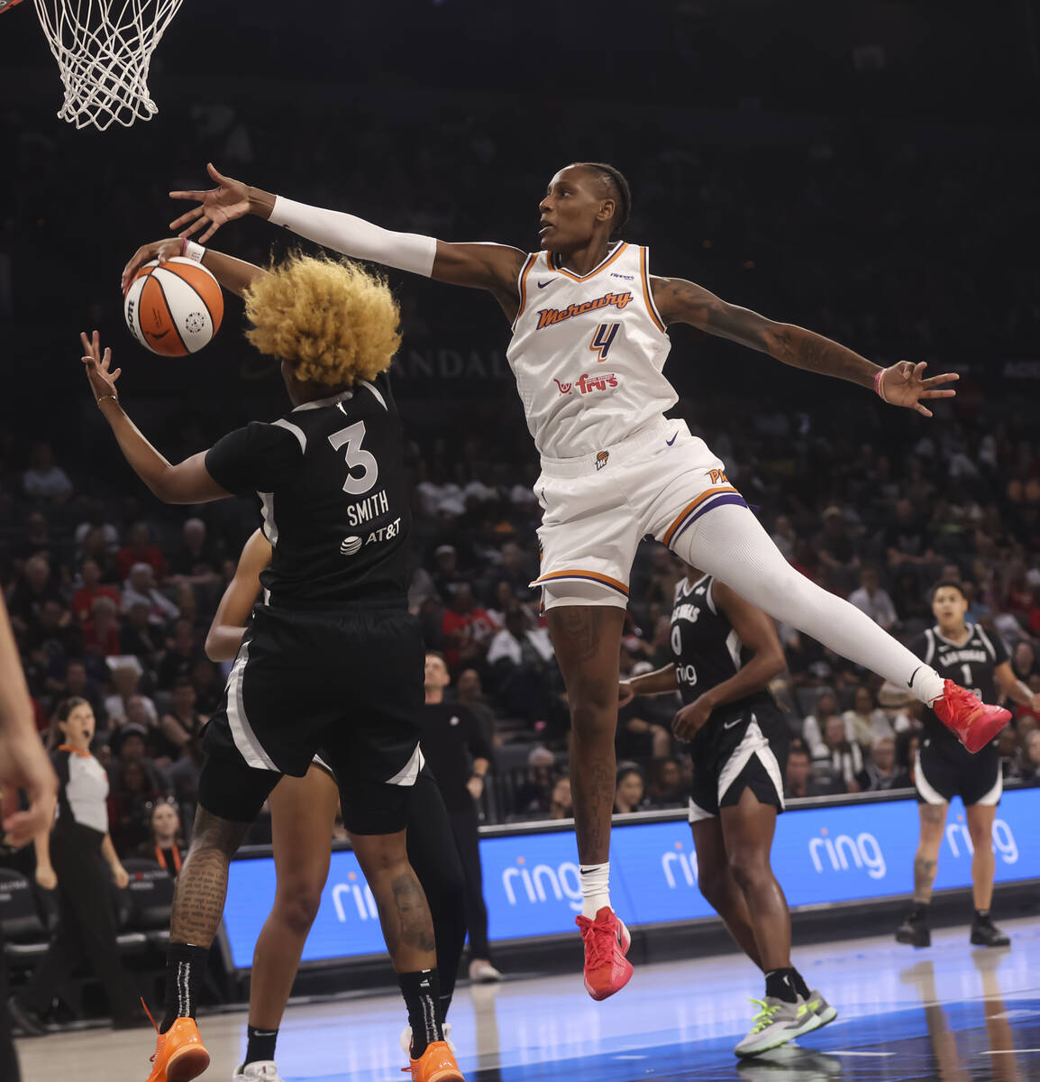 Aces forward NaLyssa Smith (3) grabs a rebound against Phoenix Mercury forward Natasha Mack (4) ...