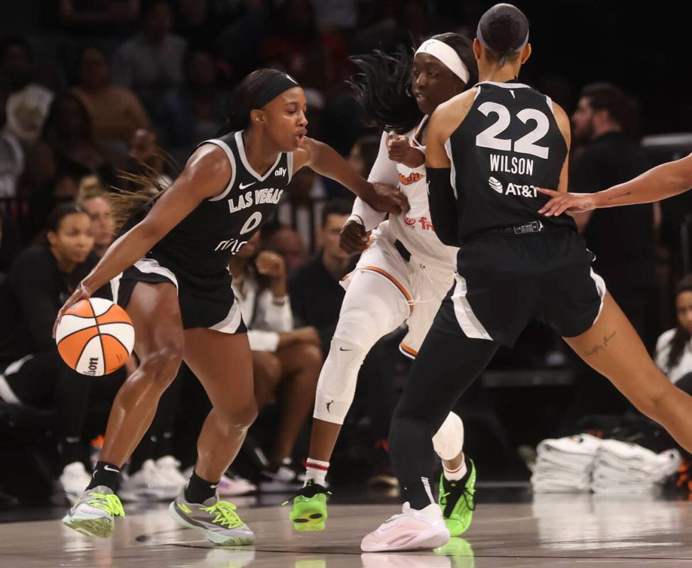 Aces guard Jackie Young (0) drives to the basket as Aces center A'ja Wilson (22) screens Phoeni ...