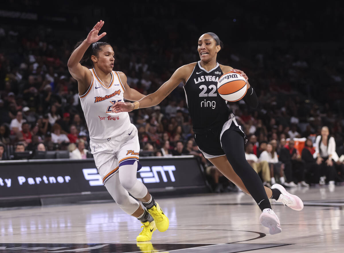 Aces center A'ja Wilson (22) drives to the basket against Phoenix Mercury forward Alyssa Thomas ...