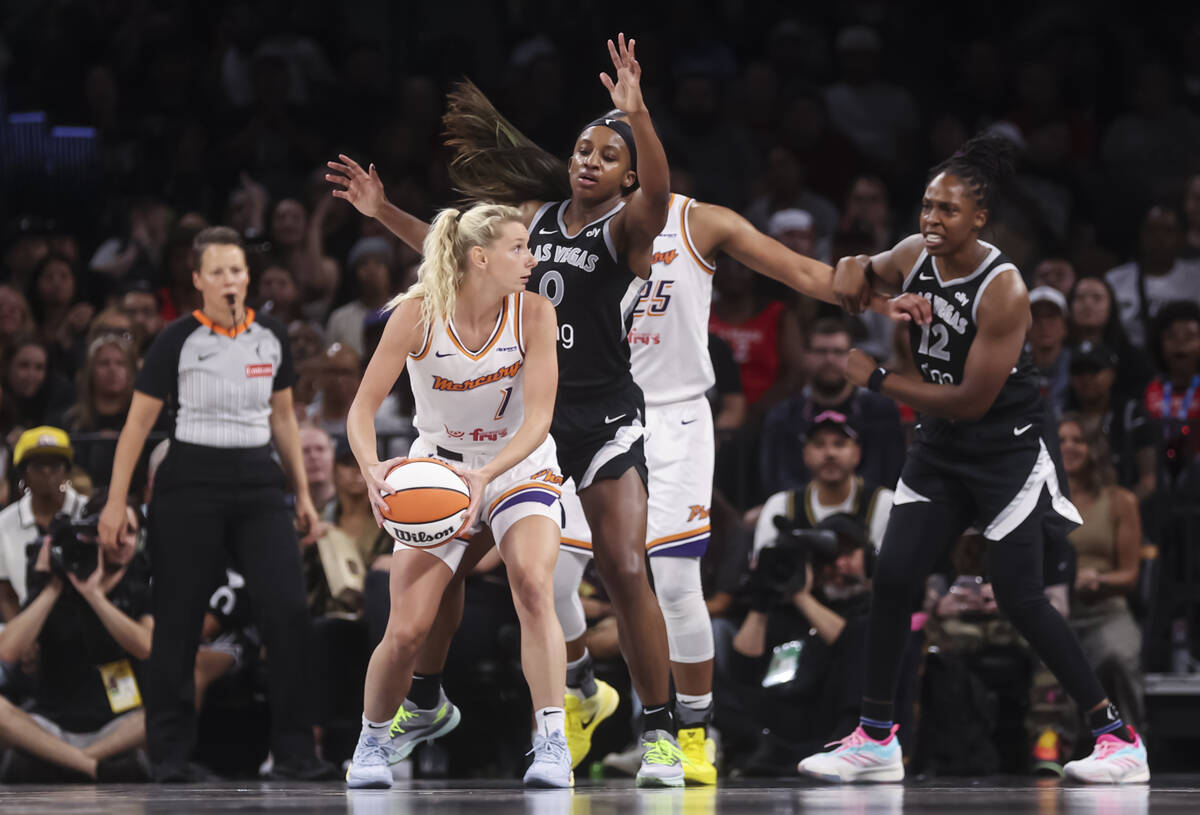 Phoenix Mercury guard Lexi Held (1) looks to get around Aces guard Jackie Young (0) during the ...