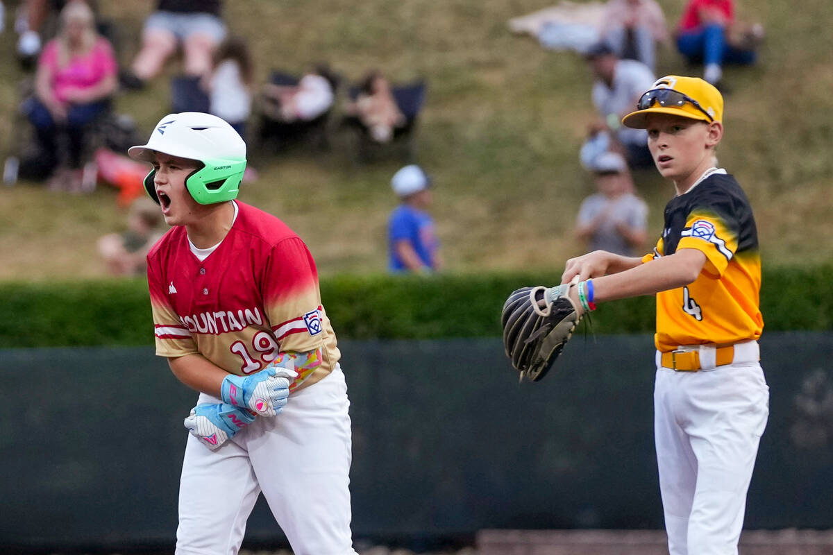 Las Vegas, Nev.'s Garrett Gallegos, left, celebrates after a hit during the first inning of a b ...