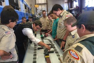 Nevada State Railroad Museum volunteer Dillon Battaglia shows a group of Boy Scouts how to oper ...