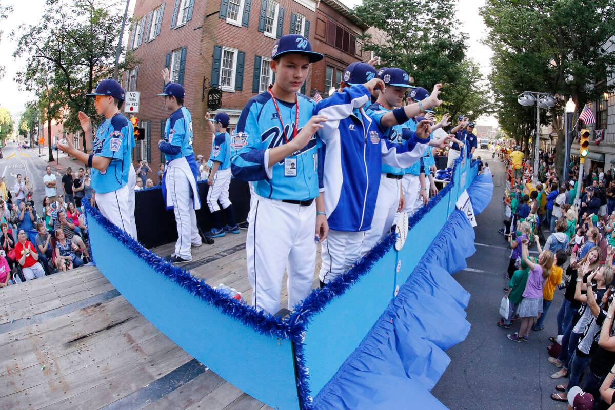 The Mountain Ridge Little League team from Las Vegas, Nev., rides in the Little League Grand Sl ...