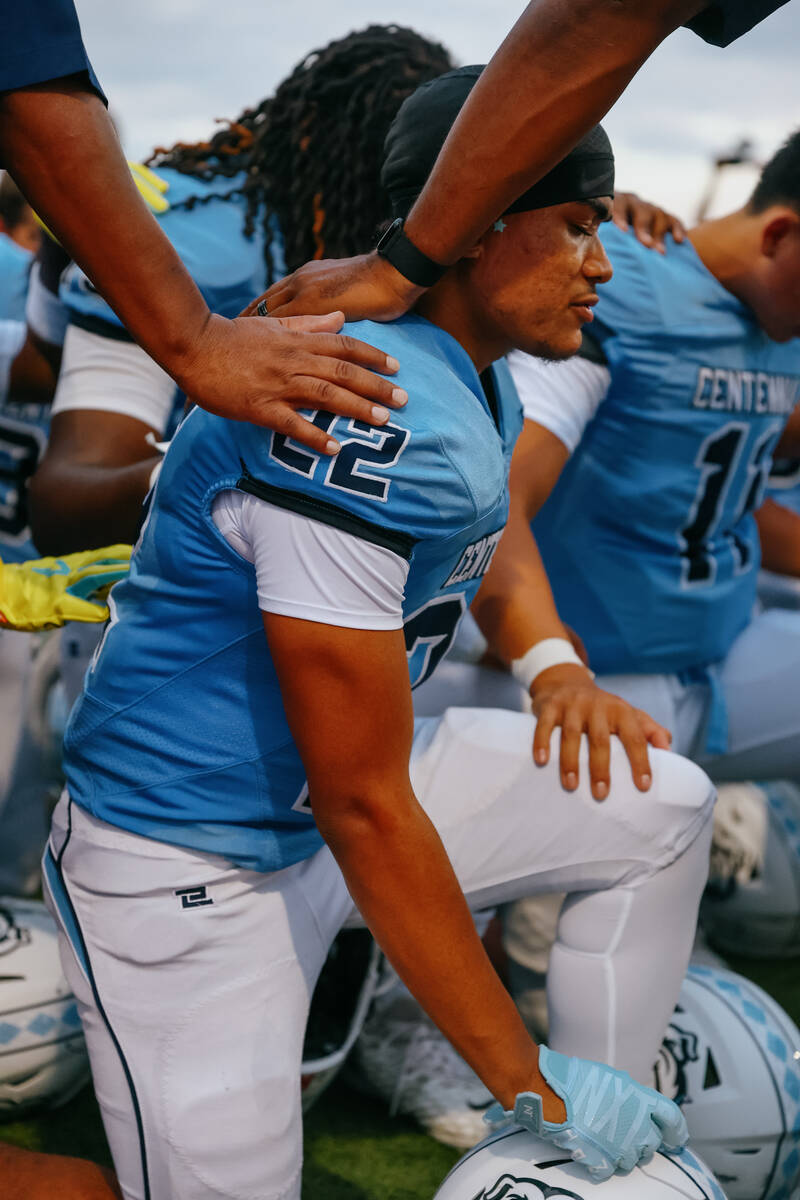 Centennial’s Jaden Williams (22) prays the Our Father with his team before the football ...