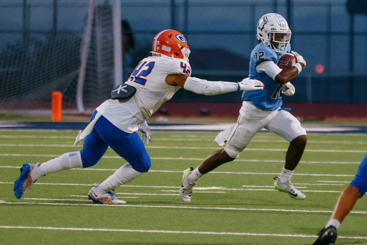 Bishop Gorman middle linebacker Raiden Johnson (42) goes for the tackle as Centennial’s ...