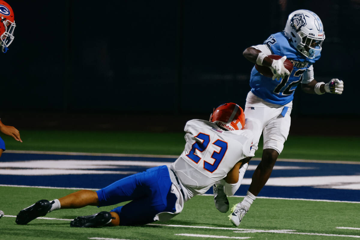 Centennial’s Nehemiah Dunlap Myvett (12) tries to get away from Bishop Gorman defensive ...