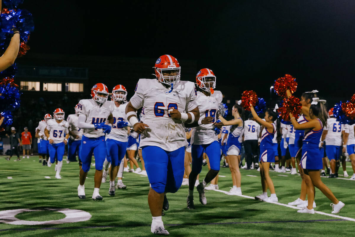 Bishop Gorman players run between cheerleaders to celebrate their win against Centennial after ...