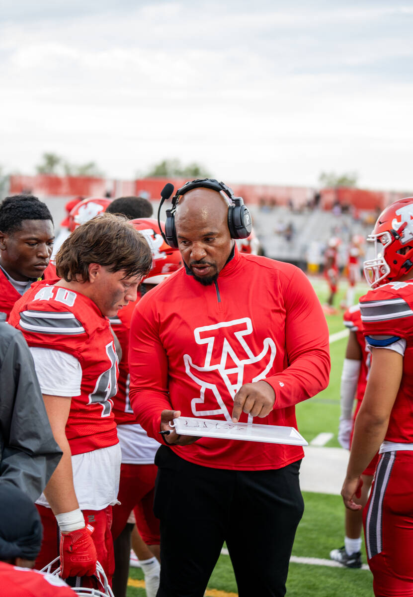 Arbor View discusses strategies during a timeout at a football game between Mililani and Arbor ...
