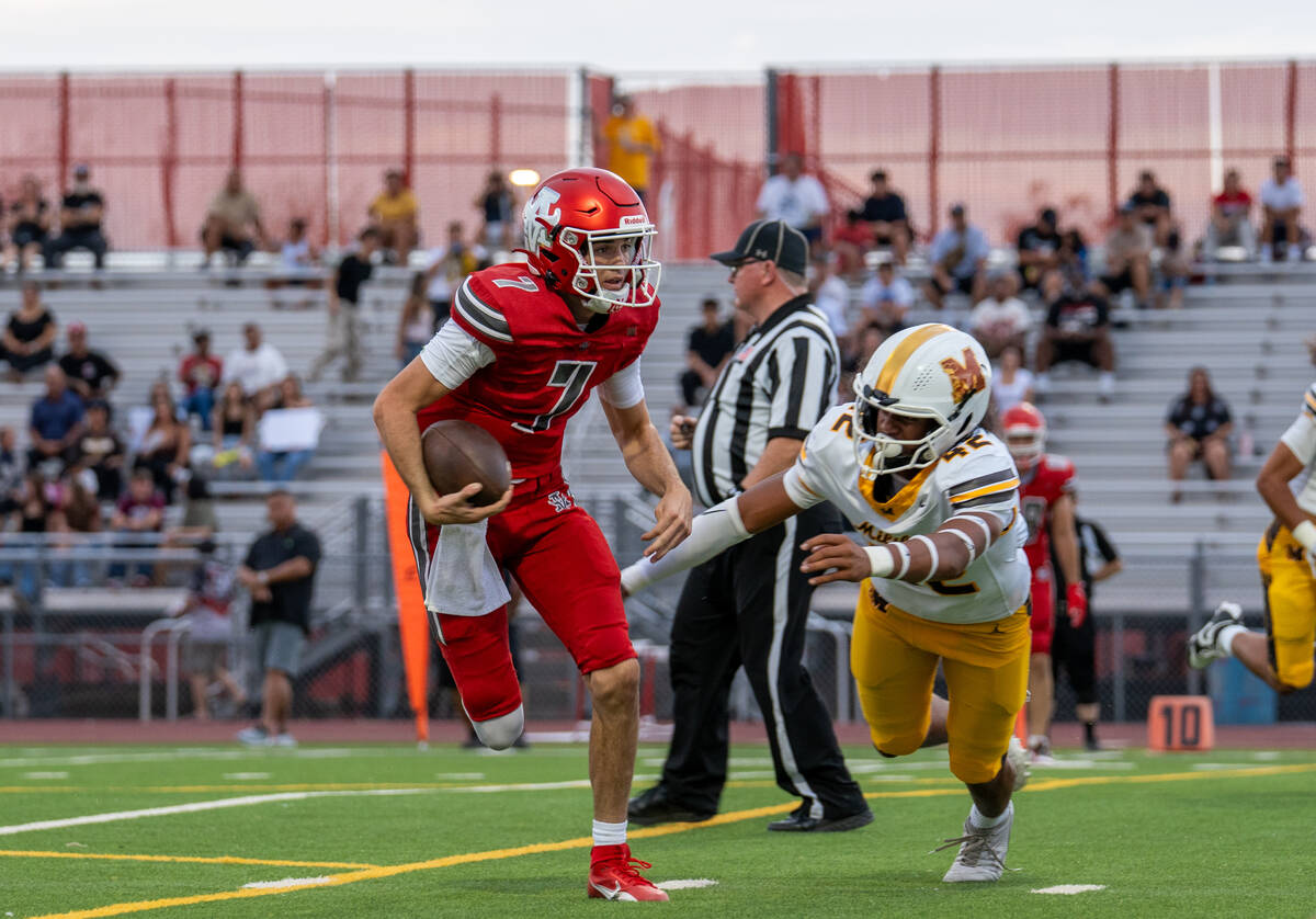 Arbor View Quarterback Thaddeus Thatcher (7) navigates through defenders during a football game ...