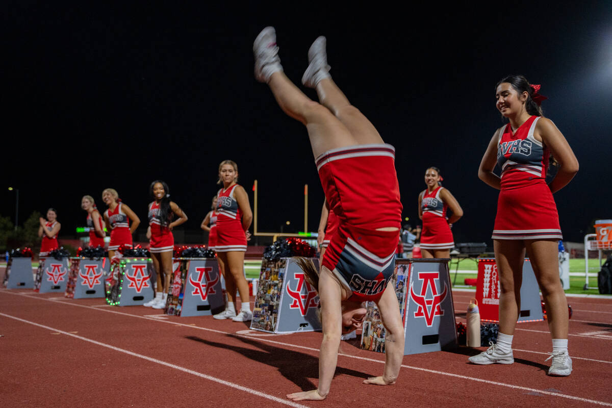 The Arbor View cheerleaders perform in front of their student section during a football game be ...
