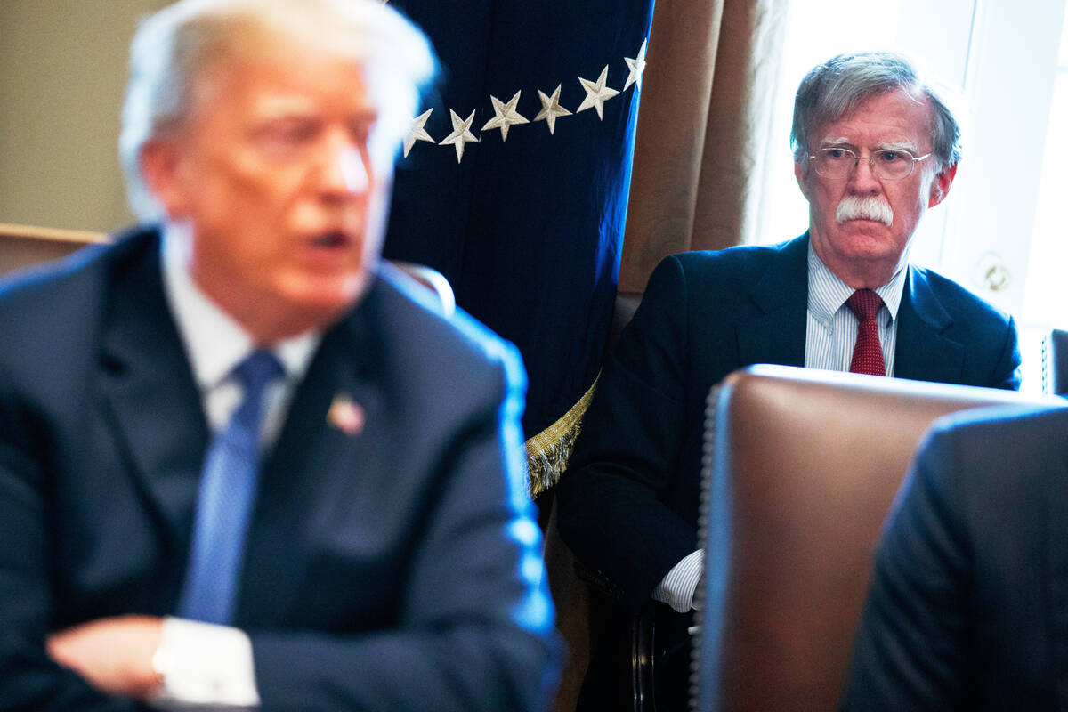 FILE - National security adviser John Bolton listens as President Donald Trump speaks during a ...