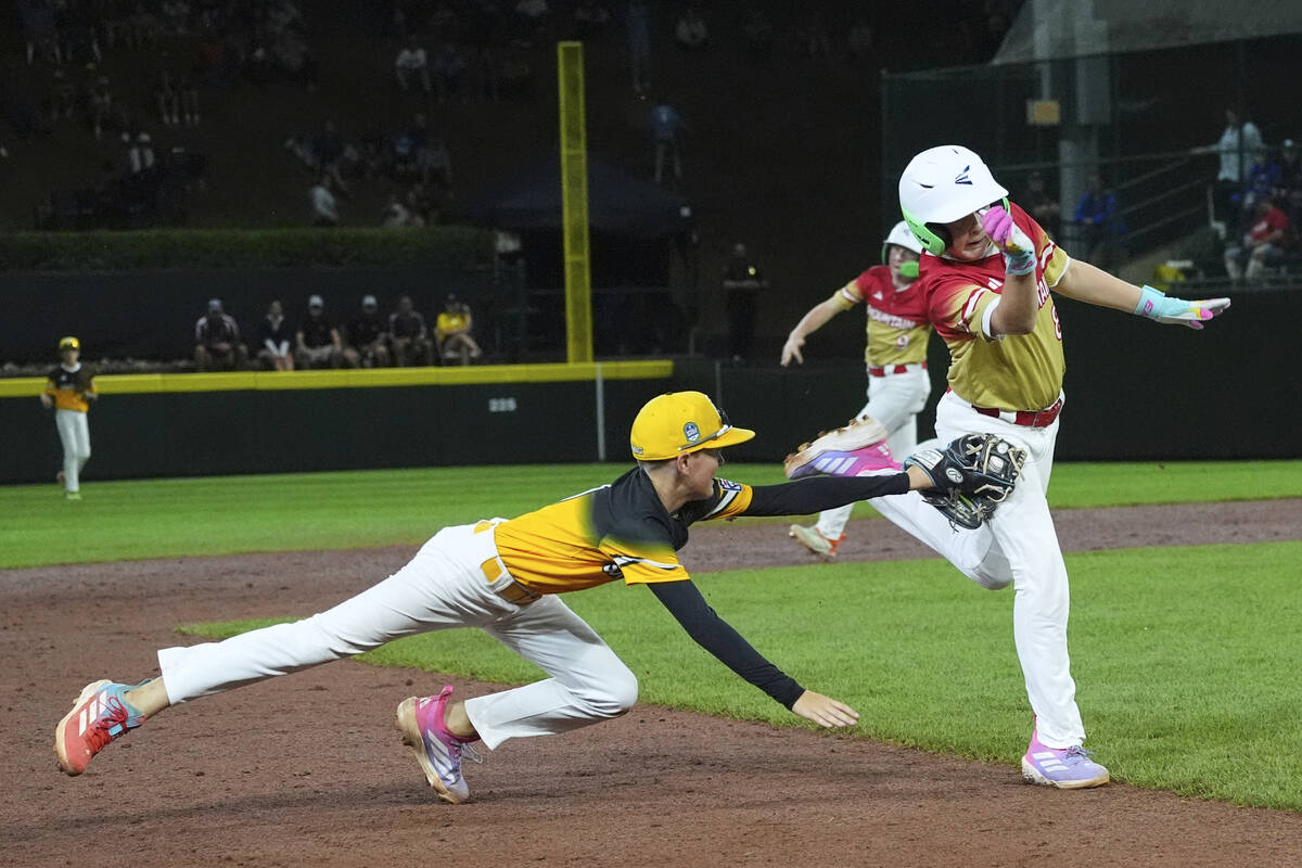 Irmo, S.C.'s Brady Westbrooks, left, tags Las Vegas' Banks Mossler, right, during the fift ...