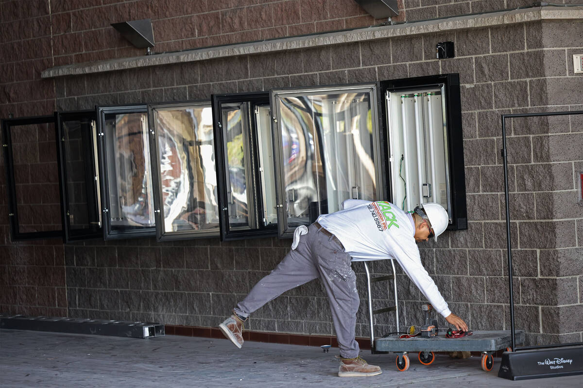 A worker with Yack Construction is seen in the shuttered movie theater in Las Vegas' Village Sq ...