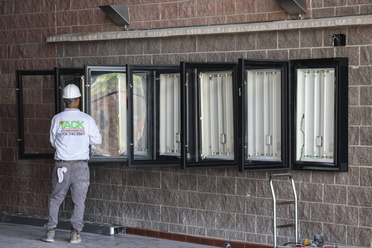 A worker with Yack Construction is seen in the shuttered movie theater in Las Vegas' Village Sq ...
