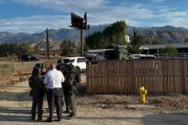 Law enforcement officials in San Bernardino County, Calif., conduct an investigation Friday, Au ...