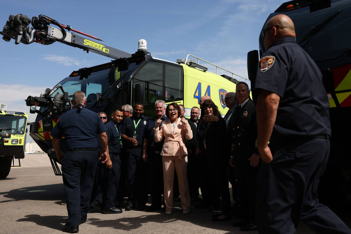 Sen. Jacky Rosen, D-Nev., takes photos with Clark County fire fighters during an unveiling cere ...