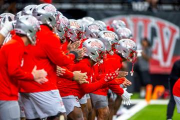 UNLV players get pumped up during warm ups before the first half of their NCAA football season- ...