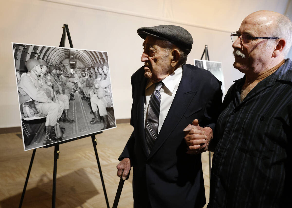 World War II veteran Onofrio "No-No" Zicari, left, and his son John look at a photogr ...