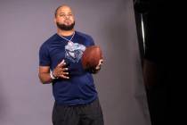 Canyon Springs football head coach Quincy Burts poses for a video during a preseason meeting an ...