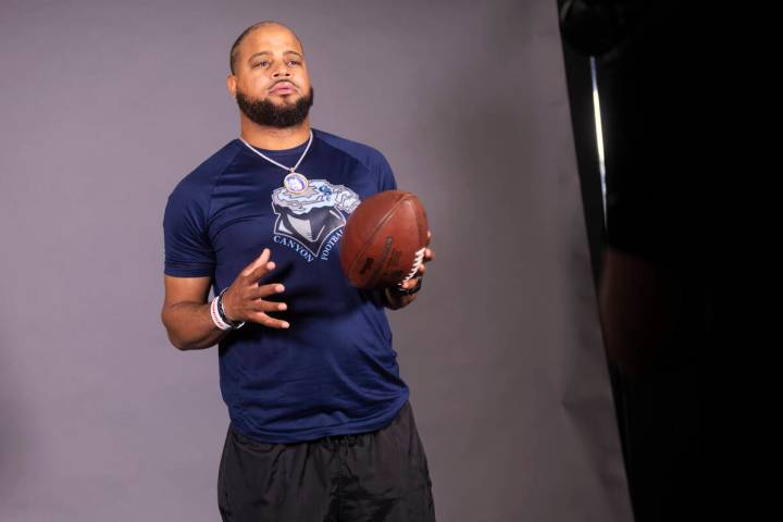 Canyon Springs football head coach Quincy Burts poses for a video during a preseason meeting an ...