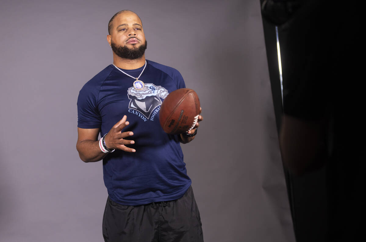 Canyon Springs football head coach Quincy Burts poses for a video during a preseason meeting an ...