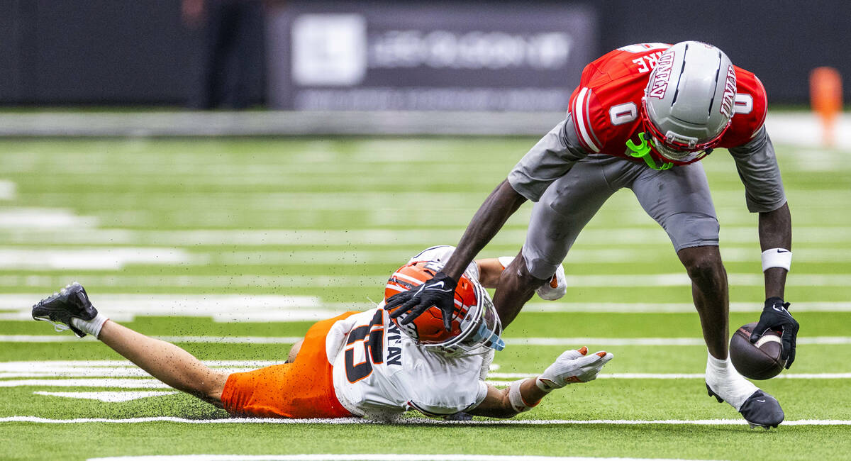 UNLV wide receiver Troy Omeire (0) attempts to break a tackle by Idaho State Bengals cornerback ...