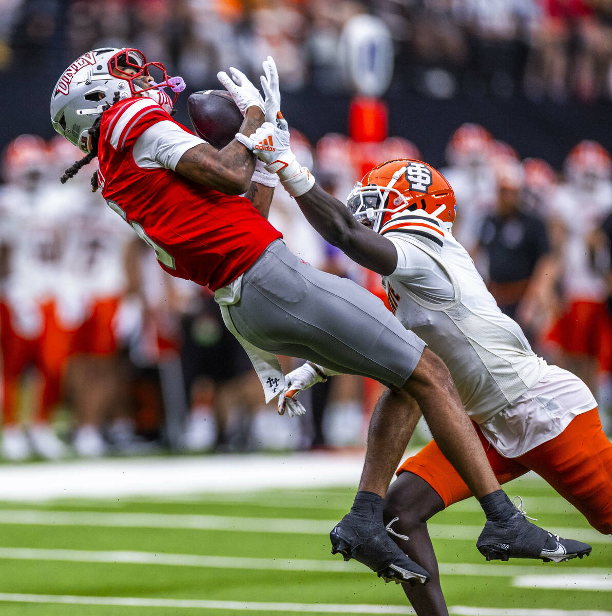 UNLV wide receiver Jaden Bradley (6) secures a deep pass over Idaho State Bengals cornerback Ga ...