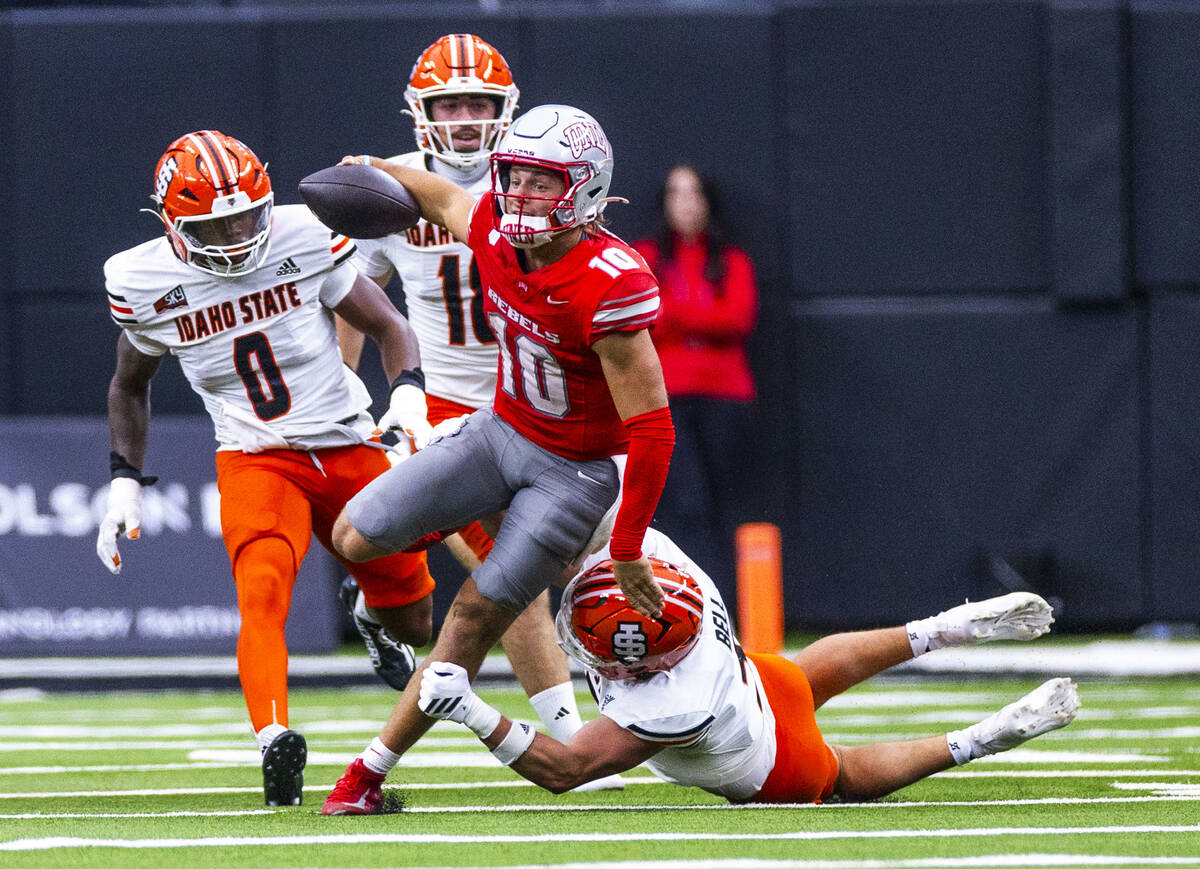 UNLV quarterback Anthony Colandrea (10) breaks free from a tackle attempt by Idaho State Bengal ...