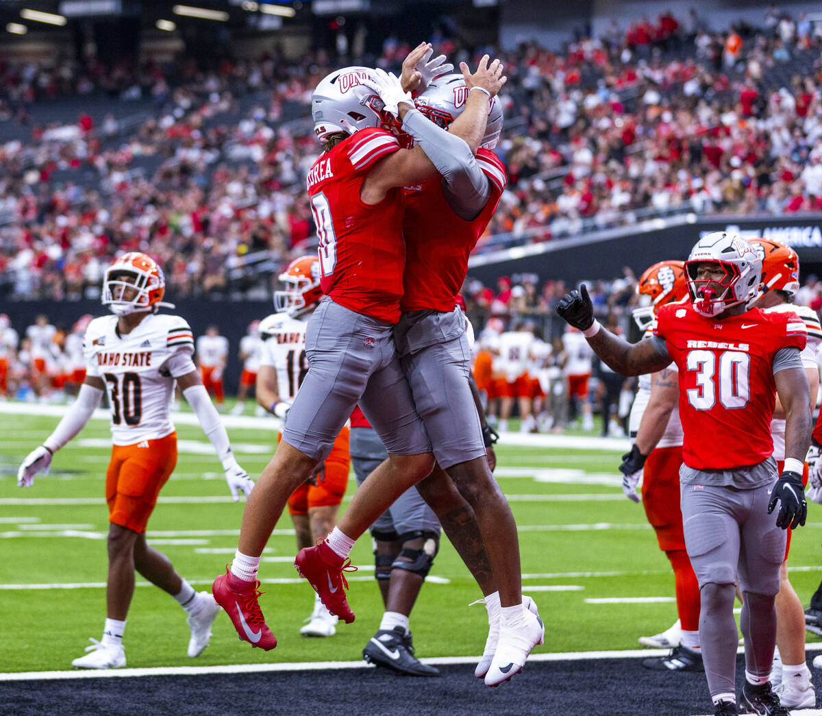UNLV wide receiver Daejon Reynolds (3) celebrates a late touchdown with quarterback Anthony Col ...