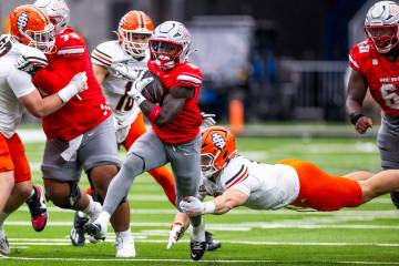 UNLV running back Jai'Den Thomas (9) breaks a against the Idaho State Bengals tackle and runs t ...