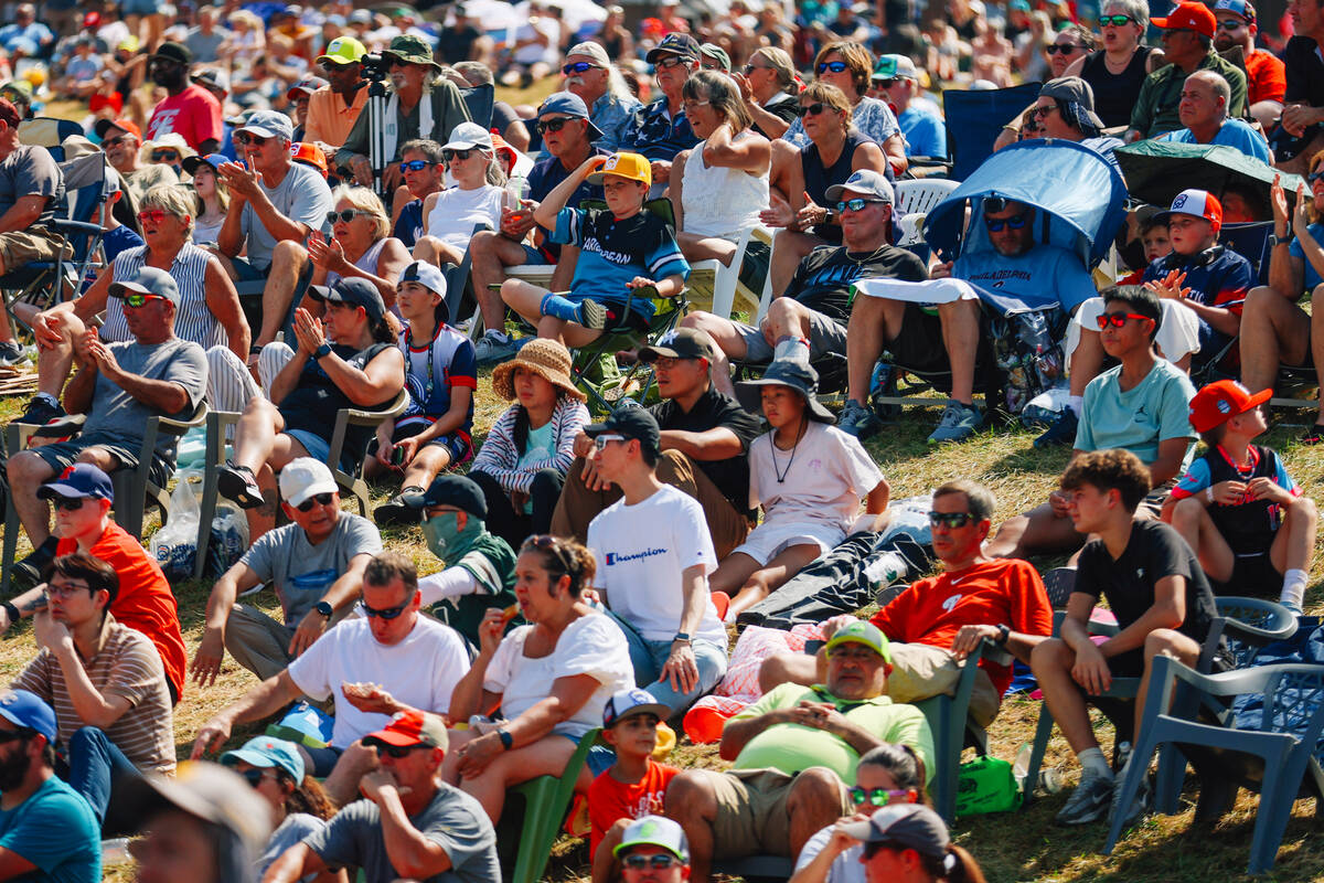 Spectators sit in the grass during a Little League World Series game at Little League Internati ...