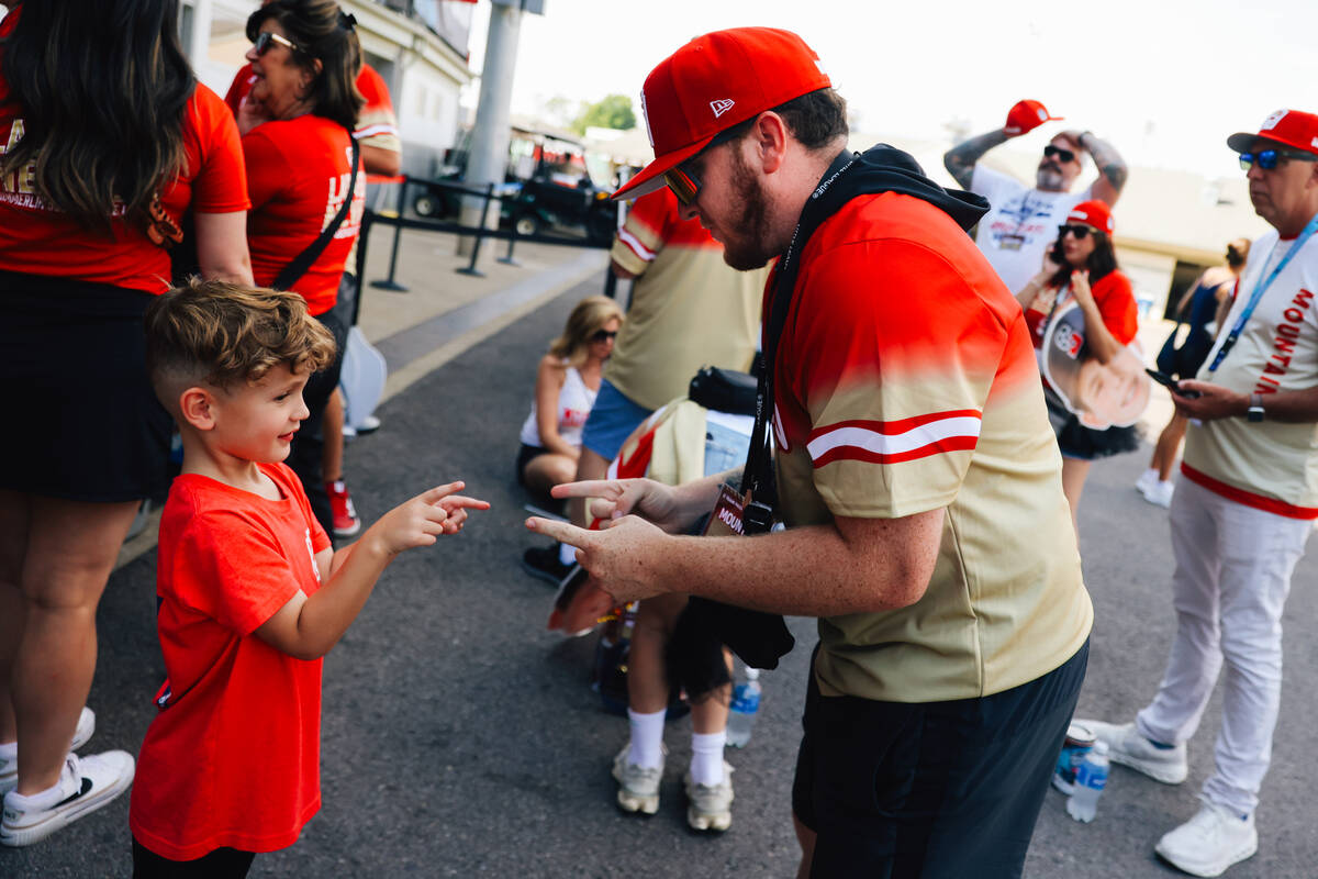 Grayson Robertson, 5, left, plays a game with fellow Summerlin South fan Donovan Souder before ...