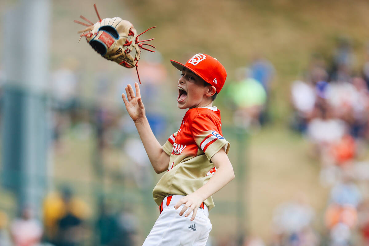Summerlin South pitcher Luke D’Ambrosio throws his mitt up in celebration after winning ...