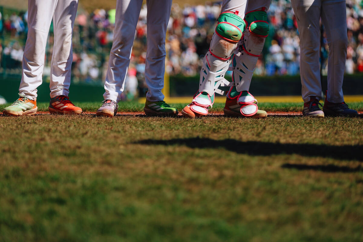 Players stand in the grass during a Little League World Series semifinals game between Summerli ...