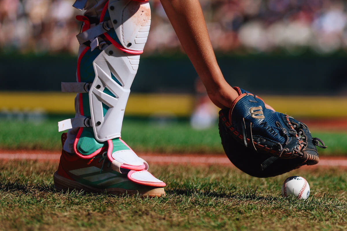A catcher picks up a ball during a Little League World Series semifinals game between Summerlin ...